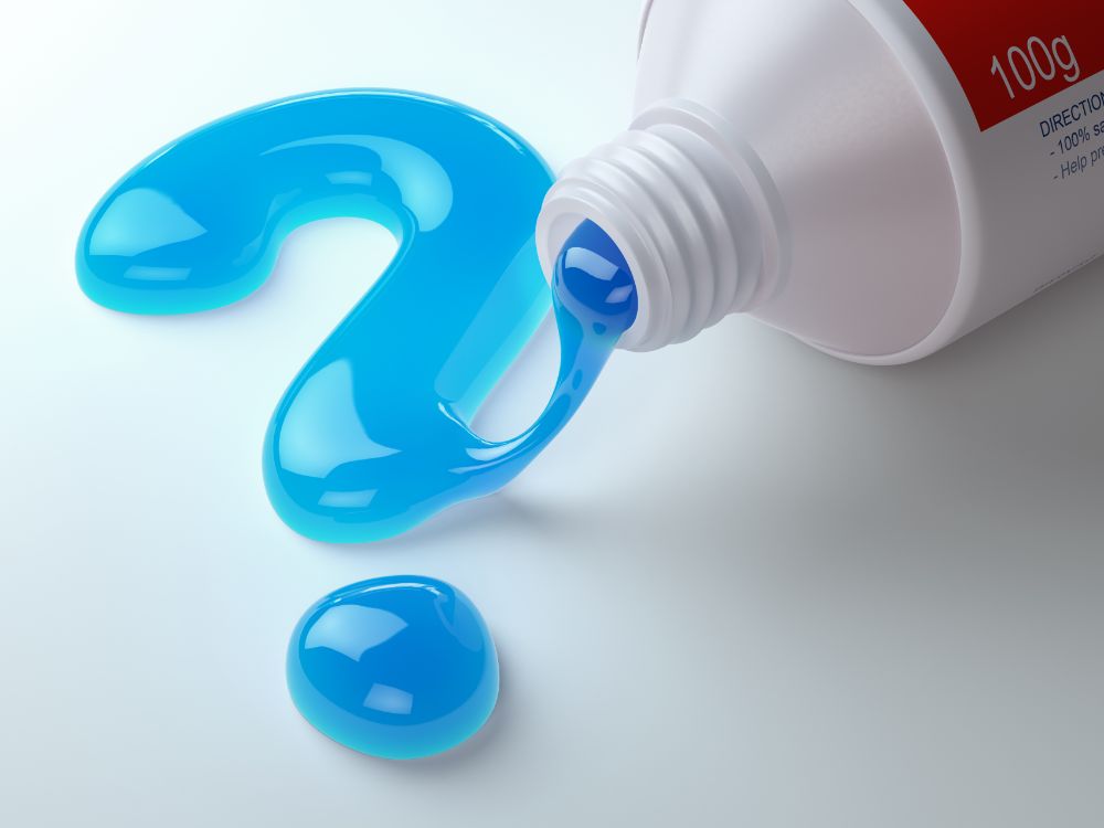 blue toothpaste squeezed on table forming a question mark